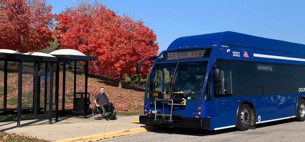 Image of a man on wheelchair boarding a Pace bus