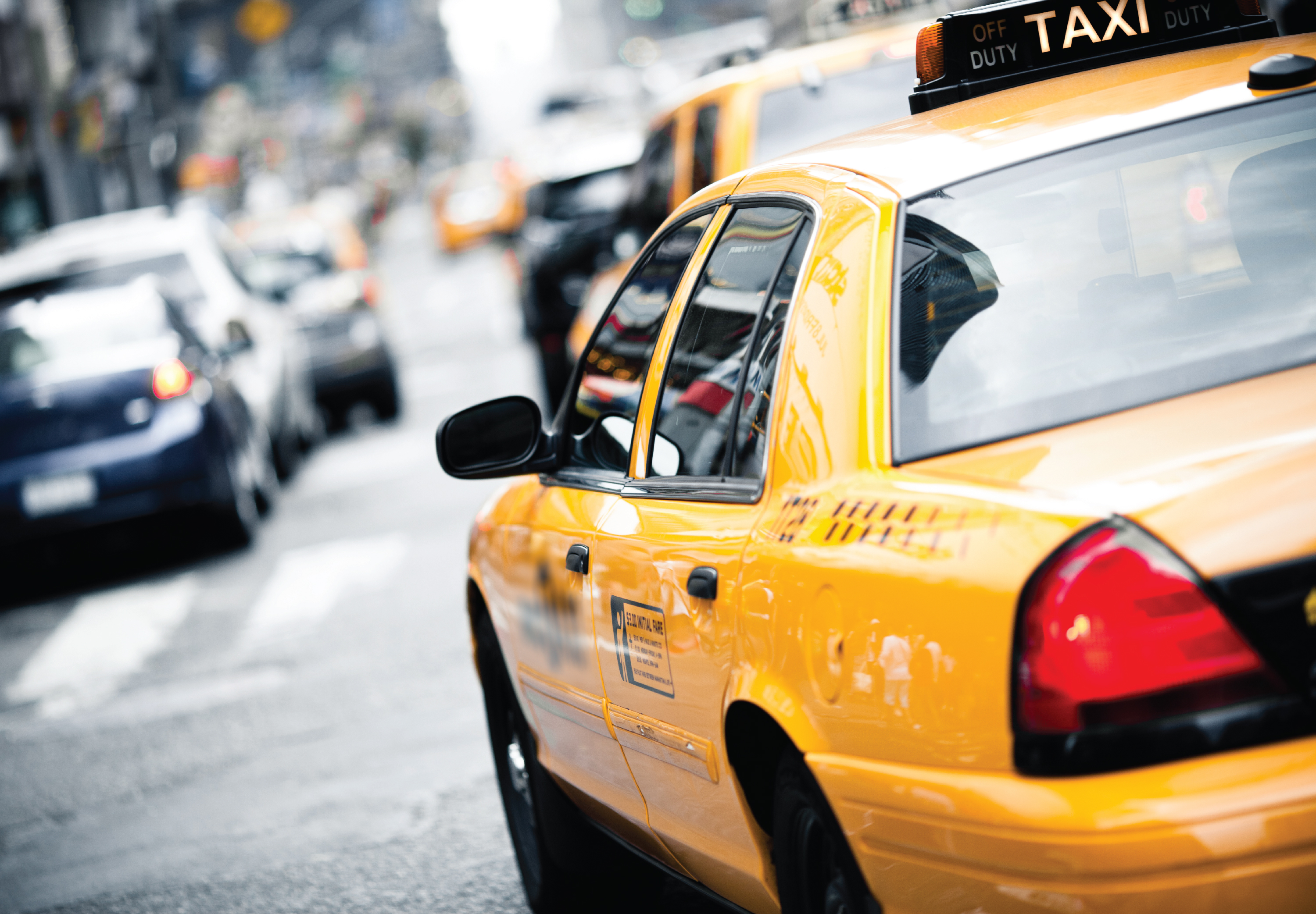 Image of Yellow Taxi in a traffic