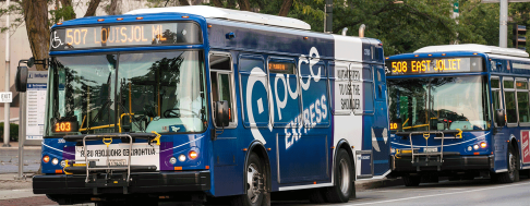 Two Pace Express buses driving down the road