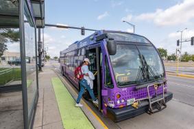 Image of a woman boarding a Pulse bus