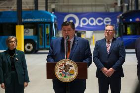 Photo of Illinois Governor JB Pritzker speaking at podium during an event in Markham
