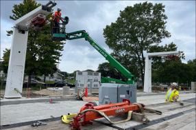 cantilevered bus chargers being installed by a crane