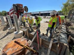 workers installing charging equipment outside Pace North Division